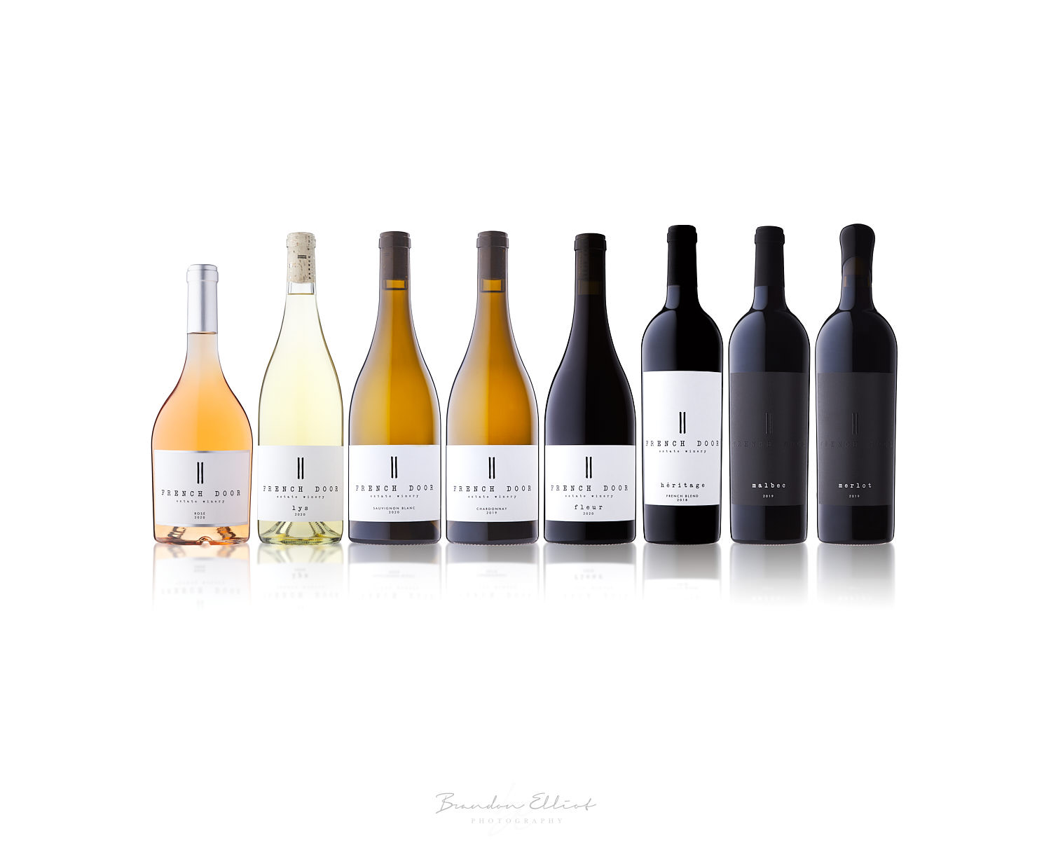rose, white wine and red wine bottle lineup by osoyoos photographer